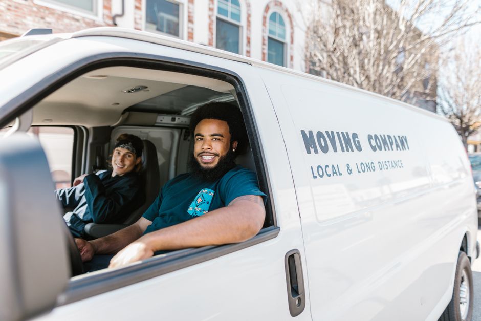 Friendly professional movers smiling