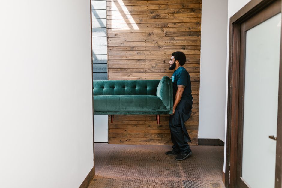 Movers carrying heavy furniture