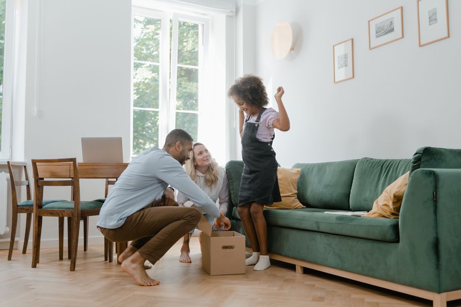 Family unpacking boxes in new home